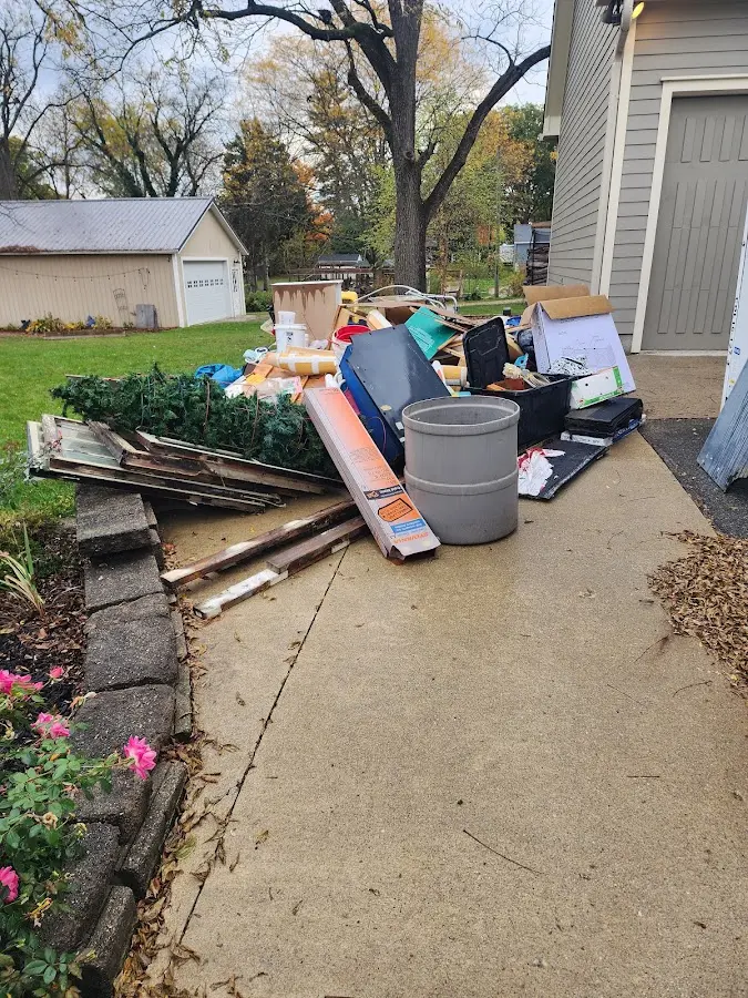 Dumpster being loaded with debris for Estate Cleanout Dumpster Rental in Orono